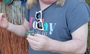 Lady Struggles With Libation