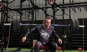 Man Lifts Weights While on Balance Board