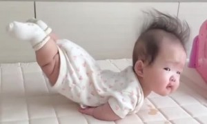 Toddler hilariously lays with her legs in the air