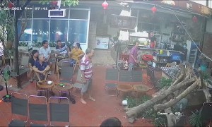 Man Drinking Coffee Dodges Falling Tree in Restaurant