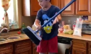 Boy Trapped by Container with Water and Broom Gets Wet