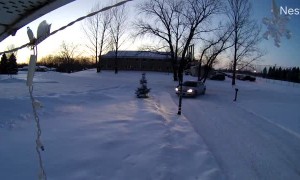 Snowmobile Crashes Into Garage Moments After Owners Leave
