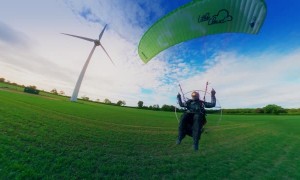 Paramotor Flies Around Wind Turbine