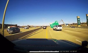Strong Winds Blow Freeway Sign onto the Road