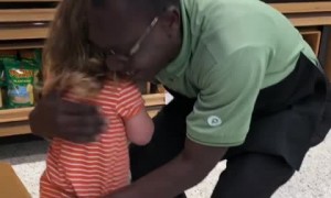 Sweet little girl gives thank you card to supermarket employee