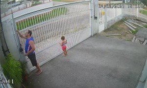 Girl Hangs on While Dad Opens Gate
