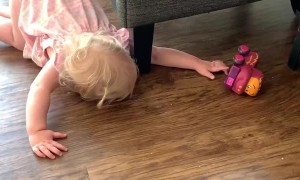 Toddler Has a Hard Time Reaching for Toy