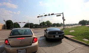 Man Points a Gun at Motorcyclist