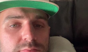 Crying Child Peeks Over Plane Seat