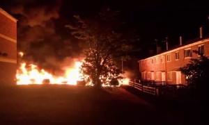 A Row of Cars on Fire