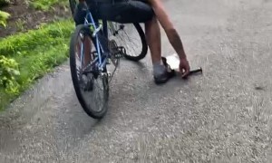 Man Apparently Falls Asleep While Riding Bike