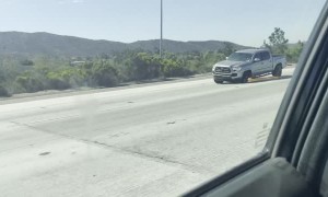 Truck with Three Wheels Hauls Down Highway