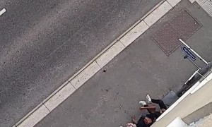 Lowering a Giant Toy Spider on Top of Guys on Street