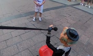 Puppeteer Improvises With a Child at Street Show