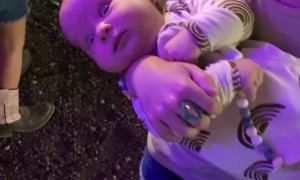 Baby Looks Terrified While Being Held By 6 Year Old Sister