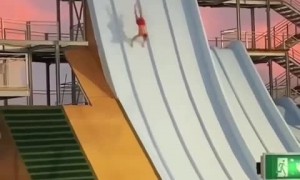 Daredevil jumps from roof of waterpark slide after doing a handstand 