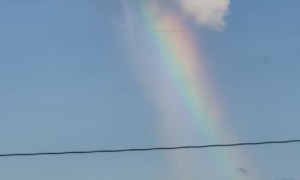 Rainbow Appears to Pour Out of Cloud