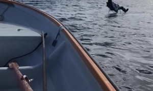 Man Fishes on Ice Block in the Middle of the Lake