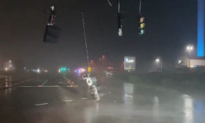 Stop lights dangle from extreme Hurricane Nicole damage
