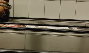 Tilted Escalator Riders in Budapest