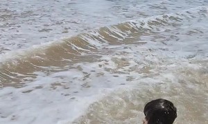 Waves Sweep This Baby Off His Feet