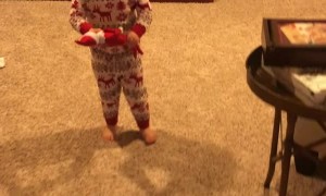 Little Girl Holds the Elf-On-The-Shelf