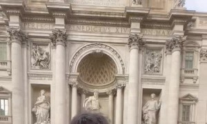 Guy Loses Balance Tossing Coin into Fountain