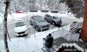 Tree Branch Comes Crashing Down While Man Shovels Snow