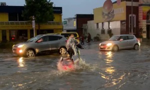 Guys Ride Through Flooded Streets on Electric Scooters