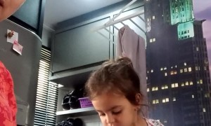 Little Girl Helping Mom Bake Mixed Cake Adds an Extra Ingredient