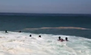 Large Waves Wash Over Beachgoers in Brazil