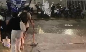 Woman Trips on Curb in Heavy Rain