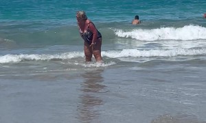 Woman Knocked Over By Wave