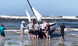 Beachgoers Work to Rescue Boat
