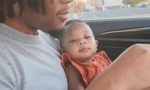 Precious daughter gazes at her dad with adoring glance 