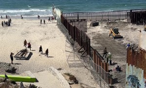 Migrants and Stray Dog Run Across Open US-Mexico Border Fence in Tijuana