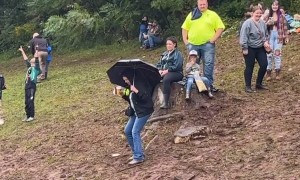 Woman Slips on Muddy Slope