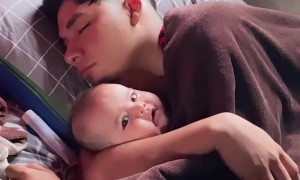 Sleeping Dad Cuddles Infant Daughter