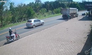 Motorcyclist Wheelies Into Oncoming Truck