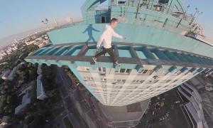 Daredevil Makes Precarious Dash Across  High-Rise Rooftop