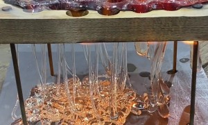 Dripping Molten Glass Over a Wooden Board With Holes