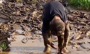 Boy Plays in Mud Puddle
