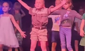 Confident kid has a blast dancing on a stage 