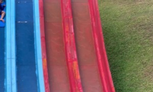 Guy Helps Boy Stuck in the Middle of Water Slide