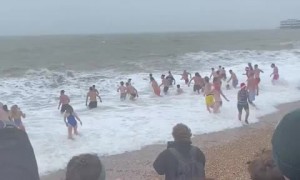 Wind, rain and waves for the annual Christmas Day swim on Brighton Beach