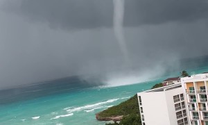 Waterspout Towers Over Shore