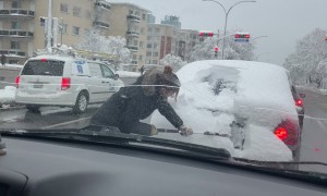 Cleaning Snow Off Stranger's Back Window