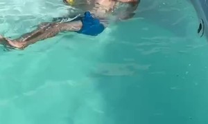 Man in Pool Tries to Save His Drink
