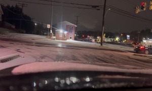 Vehicles Struggle to Stop at Icy Intersection