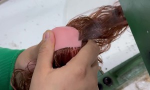 Doll Maker Sews On Hair